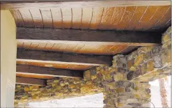  ??  ?? Since the complement­ary look of wood is timeless, faux wood beams can be utilized to embellish a home’s exterior ceiling as well.