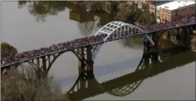  ?? BUTCH DILL, FILE — ASSOCIATED PRESS ?? In this March 8, 2015, photo, a large crowd moves in a symbolic walk across the Edmund Pettus Bridge, in Selma, Ala., to mark the 50th anniversar­y of “Bloody Sunday,” a civil rights march in which protestors were beaten, trampled and tear-gassed by...