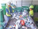  ?? USA TODAY NETWORK ?? Workers at Waste Management Recycling Brevard in Cocoa, Fla., sort through the contents of a truck separating the items that can not be recycled.