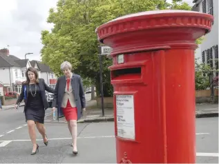  ?? — Reuters ?? British Prime Minister Theresa May campaignin­g with local Conservati­ve candidate Joy Morrissey in Ealing.