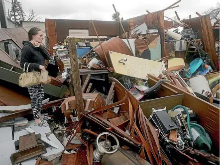  ?? AP ?? Haley Nelson inspects damages to her family properties in Panama City, Florida, after Hurricane Michael made landfall in Florida’s Panhandle yesterday.