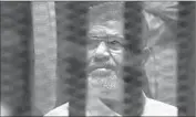  ?? Amr Nabil Associated Press ?? OUSTED EGYPTIAN President Mohamed Morsi is held in a glass enclosure in court in Cairo.