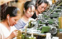  ?? AFP / Getty Images ?? Workers produce clothes for export at a factory in Xiayi county, in Shangqiu in China's central Henan province.