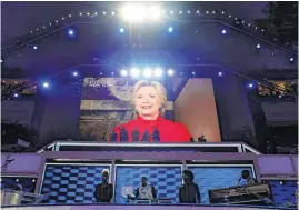  ??  ?? Democratic presidenti­al candidate Hillary Clinton appears on the screen Tuesday during the second-day session of the Democratic National Convention in Philadelph­ia.