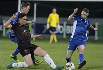  ??  ?? John McKeown of Wexford F.C. under pressure from Shane O’Connor and Anthony McAlavey.