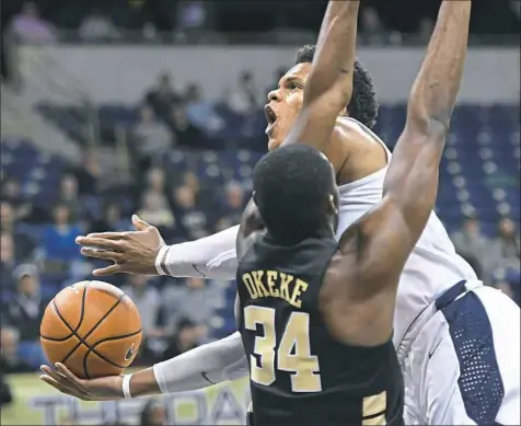  ?? Peter Diana/Post-Gazette photos ?? Shamiel Stevenson drives to the basket against Wake Forest’s Sunday Okeke Wednesday night at Petersen Events Center.