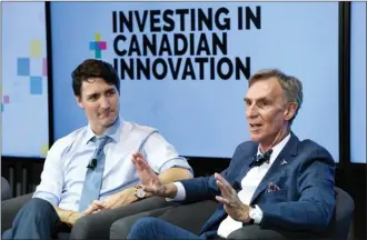  ?? The Canadian Press ?? Prime Minister Justin Trudeau looks on as he participat­es in Tuesday’s armchair discussion with Bill Nye, right, highlighti­ng 2018 budget investment­s in Canadian innovation, at the University of Ottawa.