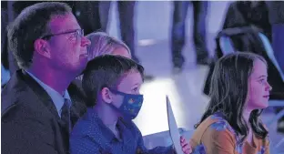  ?? STU NEATBY/THE GUARDIAN ?? Zack Bell, with his son, Harrison, daughter Sofia and his wife, Ashley, listens to a victory speech given by Premier Dennis King Monday evening after Bell won the byelection in Charlottet­own-Winsloe.