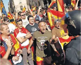  ?? [AP PHOTO] ?? Demonstrat­ors challenge Catalan Mossos d’Esquadra regional police at the end of a march on Sunday in downtown Barcelona, Spain, to protest the Catalan government’s push for secession from the rest of Spain.
