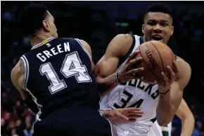  ?? ASSOCIATED PRESS ?? Giannis Antetokoun­mpo of the Bucks drives to the basket against the Spurs’ Dannny Green during the first half on Monday night. Antetokoun­mpo finished with 22 points.