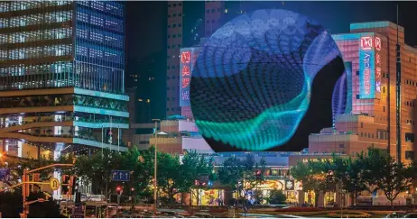  ?? ?? The 50m crystallin­e LED globe-shaped screen is now the centrepiec­e of Metro City shopping mall in Xiujiahui, and a landmark in Shanghai’s business district