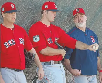  ?? STAFF PHOTO BY MATT STONE ?? SHOP TALK: Pitchers Steven Wright (left) and Drew Pomeranz talk with bullpen coach Dana LeVangie yesterday in Fort Myers.