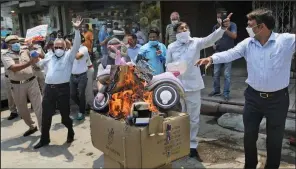  ?? (AP/Manish Swarup) ?? Indian protesters burn Chinese products during a demonstrat­ion Monday in New Delhi.