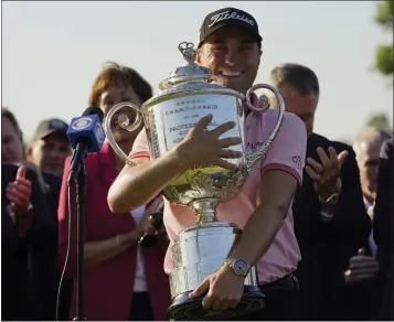  ?? ERIC GAY — THE ASSOCIATED PRESS ?? Justin Thomas holds the Wanamaker Trophy after winning the PGA Championsh­ip at Southern Hills Country Club.