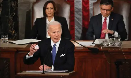  ?? Photograph: Mandel Ngan/AFP/Getty Images ?? Joe Biden holds a button with Laken Riley’s name while delivering the State of the Union address at the US Capitol in Washington DC on 7 March 2024.