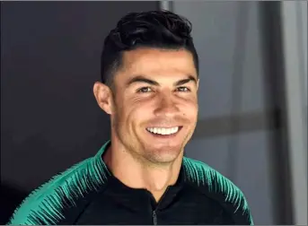  ??  ?? In this June 8 file photo, Portugal’s Cristiano Ronaldo smiles when he arrives to a training session at the Bessa stadium in Porto, Portugal. AP PhoTo/MArTIn MeIssner