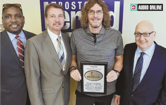  ?? STAFF PHOTO, ABOVE, BY ARTHUR POLLOCK; PHOTO, BELOW, KARISA CLEMMEY ?? HARMONIZIN­G: Ernie Boch Jr., center, yesterday presented Herald editor-in-chief Joseph Sciacca, right, with the Music Drives Us recognitio­n award. At left are Darren McNair, automotive account executive, and Joseph Lopilato, vice president...