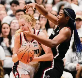  ?? Jessica Hill/Associated Press ?? South Carolina’s Aliyah Boston, right, pressures UConn’s Dorka Juhasz in the first half Sunday in Hartford.