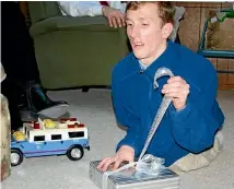  ??  ?? Max Gretschel with his Tonka truck, which is no longer being produced. His sister Cassie is trying to track down a new truck as a Christmas gift for her brother.