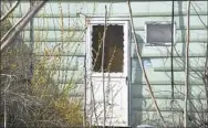  ?? Darrell Sapp/Post-Gazette ?? Two bodies were found inside this opened doorway in a home in the 900 block of Manton Way in Allentown on March 15.