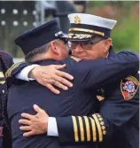  ?? CHRIS KOHLEY / MILWAUKEE JOURNAL SENTINEL ?? A member of the Sheboygan Fire Department embraces another before the funeral for Sun Prairie firefighte­r Cory Barr.