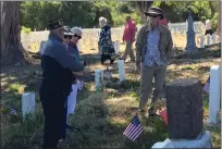  ?? ?? Veteran Jeffrey Hall, far left, as well as a few more people, pay their respects to those lost in military service while exploring the Mare Island Naval Cemetery on Monday for a Memorial Day event.