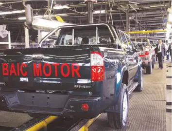  ??  ?? The new BAIC pick-up trucks being assembled at Willowvale Motor Industries during the launch in Harare yesterday. — (Picture by Innocent Makawa)