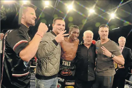  ?? Picture: GALLO IMAGES ?? CENTRE OF ATTRACTION: Thulane Mbenge is flanked by his mentors and promoter Rodney Berman (in black) after he won the IBO vacant welterweig­ht title at the ‘Bombs Away’ Box and Dine event at Convention Centre, Emperors Palace in Johannesbu­rg