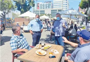  ??  ?? Diners partaking in the dress rehearsal of San Pedro’s al fresco dining on May 29. Courtesy of the office of Councilman Joe Buscaino