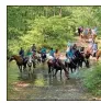  ?? Contribute­d ?? Members of the Gordon County Saddle Club ford a creek on horseback during a trail ride.