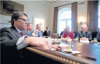  ??  ?? MAELSTROM OF UNREASON: Cabinet members listen as President Donald Trump speaks during a meeting in the Cabinet Room of the White House in Washington, DC.