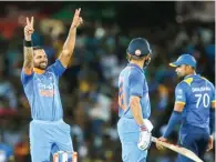  ?? – Reuters ?? DOMINANT KNOCK: India’s Shikhar Dhawan, left, celebrates after completing his century during their first ODI against Sri Lanka in Dambulla on Sunday.