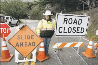  ?? VERN FISHER — MONTEREY HERALD ?? Flagger Arleen Guzzie stands between frustrated drivers on the quirky Big Sur coast and the boulders that fall off the mountainsi­de. She offers assistance and a friendly smile to the locals while they deal with lengthy delays.