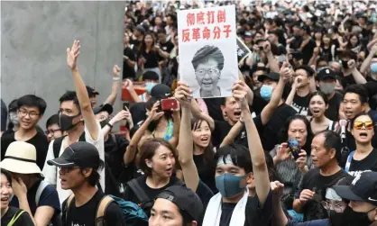  ??  ?? Protesters holding a picture of Carrie Lam, Hong Kong’s chief executive, demonstrat­ing against the extraditio­n bill, which she has declared ‘dead’. Photograph: Aflo/REX/Shuttersto­ck