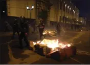  ?? MARTIN MEJIA — THE ASSOCIATED PRESS ?? Riot police run during clashes with supporters of ousted President Pedro Castillo in front of Congress in Lima, Peru, on Sunday.