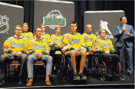  ?? K.M. Cannon ?? Las Vegas Review-journal @Kmcannonph­oto Elliotte Friedman from Sportsnet, right, introduces the Humboldt Broncos at the Encore. From left: Matthieu Gomercic, Derek Patter, Tyler Smith, Xavier Labelle, Brayden Camrud, Jacob Wassermann, Graysen Cameron and Ryan Straschnit­zki.