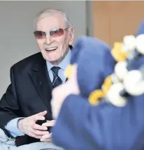  ??  ?? Levity Flight Lieutenant Ernie Holmes DFC enjoys Pipe Major Alastair Duthie’s musical salute for his 100th birthday