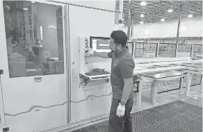  ??  ?? Oscar Bonilla processes lumber using the CNC Beam Processing Machine, which selects from multiple tools on a multiaxis robotic arm to process with precision.