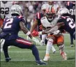  ?? STEVEN SENNE — THE ASSOCIATED PRESS ?? Cleveland Browns wide receiver Jarvis Landry (80) is surrounded while hit by New England Patriots safety Kyle Dugger, right, during the second half of an NFL football game, Sunday, Nov. 14, 2021, in Foxboro.