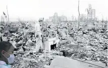  ?? Photos / AP ?? Above: An unidentifi­ed man stands in the wreckage of Hiroshima. Left: Saki Morioki, 5 years old, at the 75th anniversar­y of the atomic bombing of Hiroshima.