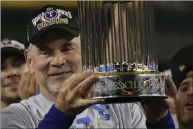  ?? BRYNN ANDERSON — THE ASSOCIATED PRESS ?? Texas Rangers manager Bruce Bochy celebrates with the trophy after winning Game 5 of the baseball World Series against the Arizona Diamondbac­ks Wednesday, Nov. 1, 2023, in Phoenix. The Rangers won 5-0 to win the series 4-1.