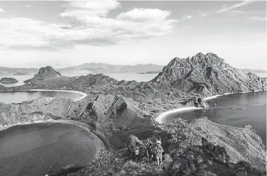  ?? Lauryn Ishak, © The New York Times Co. ?? Tourists make their way up to the viewpoint on Padar Island at Komodo National Park in Indonesia in January 2020. Such vacation spots may seem a long way away for most of us, but that doesn’t mean you can’t plan for the day you can explore the world again.