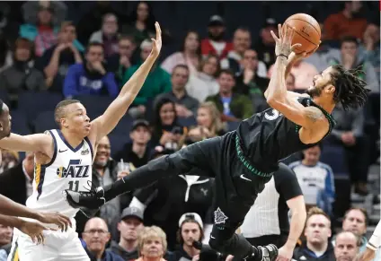  ?? AP FOTO ?? CAREERBEST. Minnesota Timberwolv­es’ Derrick Rose (right) takes a fall-back shot as Utah Jazz’s Dante Exum defends. The former MVP later got emotional after scoring a career-best 50 points against the team that waived him.