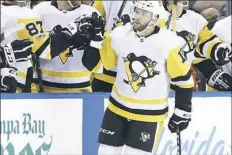  ??  ?? Bryan Rust celebrates with the Penguins bench after his goal against Tampa Bay in the second period.