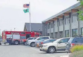  ?? [AP PHOTO] ?? Cars and emergency vehicles are seen in front of Freeman High School on Wednesday in Rockford, Wash. Authoritie­s say a shooter opened fire at the school. A suspect was apprehende­d.