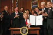  ?? CAROLYN KASTER - THE ASSOCIATED PRESS ?? President Donald Trump holds a signed Antiquitie­s Executive Order during a ceremony at the Interior Department in Washington, Wednesday. The president is asking for a review of the designatio­n of tens of millions of acres of land as “nationalmo­numents.”