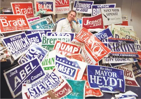  ?? MORNING CALL FILE PHOTO ?? Bill White, with his collection of political signs, sits at his desk in 1997 in the Bethlehem bureau of The Morning Call. White wrote at times about politics, taking advantage of a forum few others have to say what he felt needed to be said.