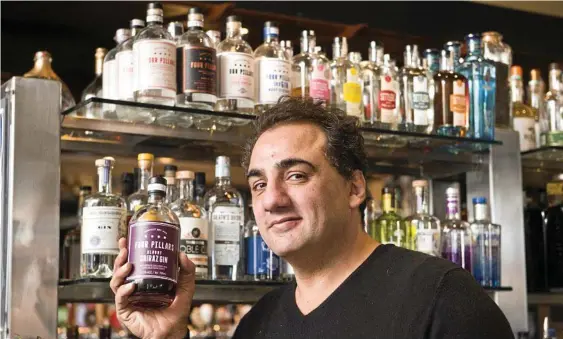  ?? Photo: Nev Madsen ?? GIN ENTHUSIAST: Phil Coorey shows the wide selection of gin that will be available at Bottomless World Wide Gin Day at the Spotted Cow on Saturday.