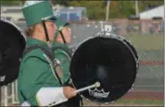  ?? ERIC BONZAR — THE MORNING JOURNAL ?? Freshman Aderika Champe beats her bass drum and fellow percussion­ist Kyile Lawson lets out a roar Sept. 15, as the Amherst High School Marching Comets make their way to the field during a road football game against the Midview Middies.