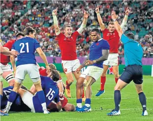  ?? AP. ?? Wales players celebrate after Ross Moriarty scores the decisive try.